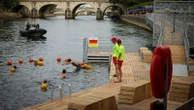 Joyful Parisians take a historic plunge into the Seine after 100 years