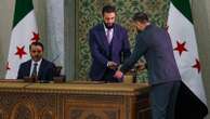 Syrian leader signs constitution that puts the country under an Islamist group's rule for 5 years