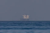 Bitcoin loses $77,000, ether, solana slide as Hormuz standoff lifts oil to 3-week high