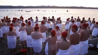 Swimmers strip down and the ocean during winter solstice