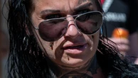 Mum of 7 with face tat accused of axe threat