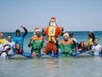 Surfing Santa delights kids with autism at Trigg Beach