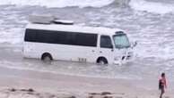 Bizarre sight of bogged bus at beach