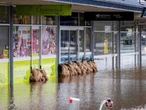 Floods submerge town centres and isolate communities