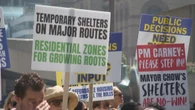 Protesters, counter-protesters face off outside Toronto city hall over bike lanes, proposed shelters