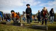 Children lay poppies on veterans' headstones in B.C. as part of No Stone Left Alone initiative