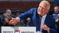 Premier pours out a bottle of Crown Royal to protest Diageo closing an Ontario plant