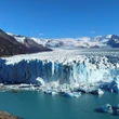 Tourists watch as a massive chunk of ice breaks off Argentinian glacier