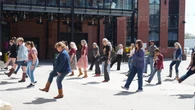 Line dancers worldwide are staging flash mobs. Is your city in for boot scooting?
