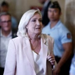 French court opens door for Marine Le Pen to run for president, with ankle monitor