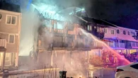 Woman jumps from 2nd floor to escape row home fire