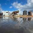 Israeli airstrikes hit Gaza as heavy rains flood camps for displaced Palestinians