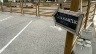 A patio is blocking accessible parking in Belmont Village. Advocates say that's not fair