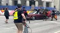 Vehicle drives through crowd during protest at Portage and Main