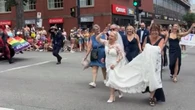 The road to this couple's wedding included a brief dance party with the Halifax Pride parade