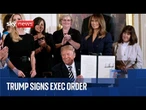 Trump signs an executive order with the First Lady