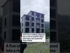 Building collapses into river in southern China