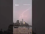 Moment lightning strikes One World Trade Center illuminating NYC skyline
