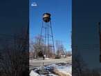 Water tower narrowly misses crashing into home