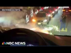 Waymo car travels over lit firework as other cars run out of battery in holiday gridlock