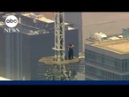 Masked climbers get engaged on the spire of the Empire State Building