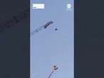 Paraglider gets caught on giant construction crane in China