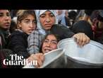 Palestinians scramble for food at soup kitchen in Khan Younis as they await ceasefire