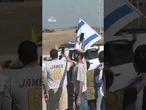 Crowd in Israel cheer on convoy believed to be carrying released hostages