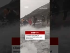 Climbers were forced to pass through fast-flowing water on Malaysia's Mount Kinabalu. #BBCNews