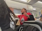 Woman apologizes to fellow passengers before squatting in aisle to relieve herself