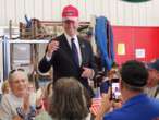 Joe Biden wears Trump hat during awkward photo op