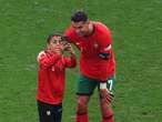 Two fans get on field for selfies with Cristiano Ronaldo during match at Euro 2024