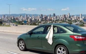 Muchos cuelgan una tela blanca en la ventana de un coche que va en movimiento: por qué lo hacen y para qué sirve 