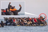Migrants celebrate & take selfies on dinghy as they dodge cops to cross Channel