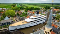 Plush £150m superyacht with jacuzzi & helipad squeezes through Dutch canal