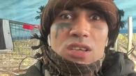 Moment migrant threatens to 'pop, pop, pop' Farage while making gun gesture