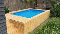 I made my own built-in outdoor pool using old palettes and a cheap paddling pool