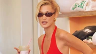 Bella Hadid turns heads in red top & checked pants as she mixes with fans