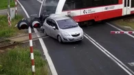 Moment driver smashes through barrier before being wiped out by train