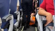 Moment plus-sized passenger who demanded aisle seat is DRAGGED off plane