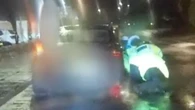 Moment mum drags two cops down road with her car after she was pulled over