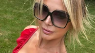 Lizzie Cundy looks stunning as she soaks up the sun in plunging red swimsuit