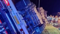 Major A-road closed after lorry crashes & overturns as drivers face long delays