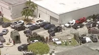Three shot at car dealership as masked man with rifle storms business