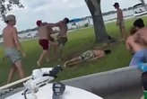 Moment man is knocked out in vicious brawl… before bikini-clad woman gives CPR