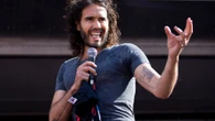 Russell Brand’s first appearance since rape charges AXED by US college
