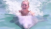 Corrie star slammed for animal cruelty as she RIDES a dolphin on hols