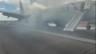 Moment 150 passengers flee plane engulfed in smoke after fault sparked fire