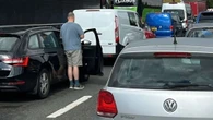 Major motorway brought to a standstill with drivers getting out of their car