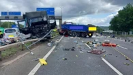 Crash between EIGHT lorries and cars sees beer barrels strewn across motorway